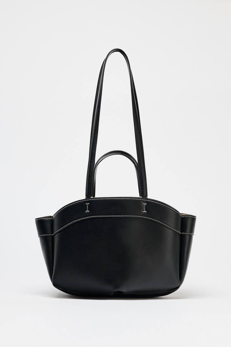 Black handbag with a handle on a white background